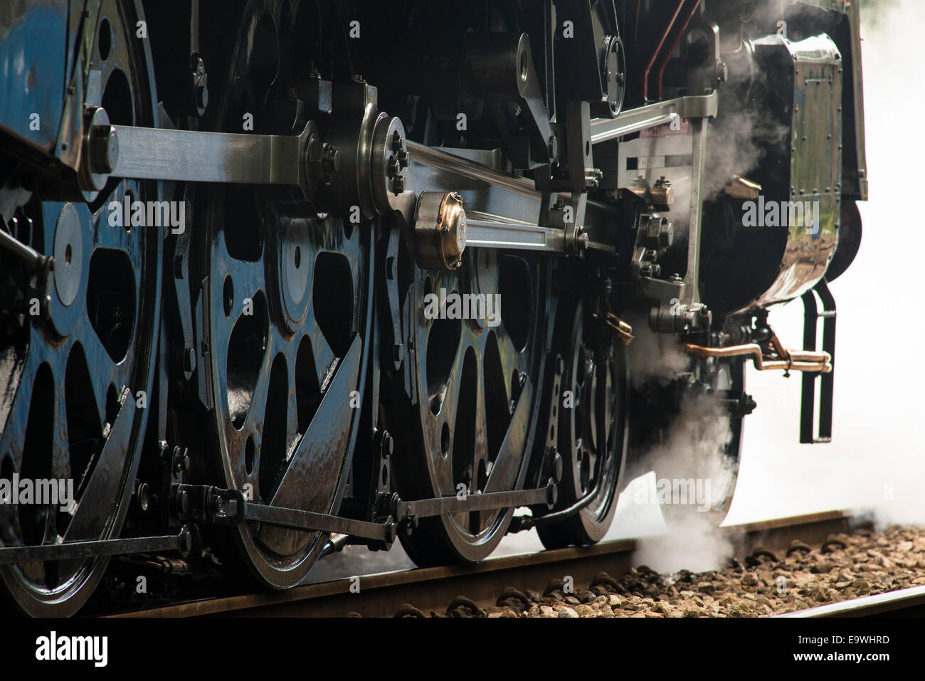 Close up drive wheels of a departing steam engine train.  Train is BR(S) Merchant Navy Class 4-6-2 no 35028 Clan Line. Stock Photo