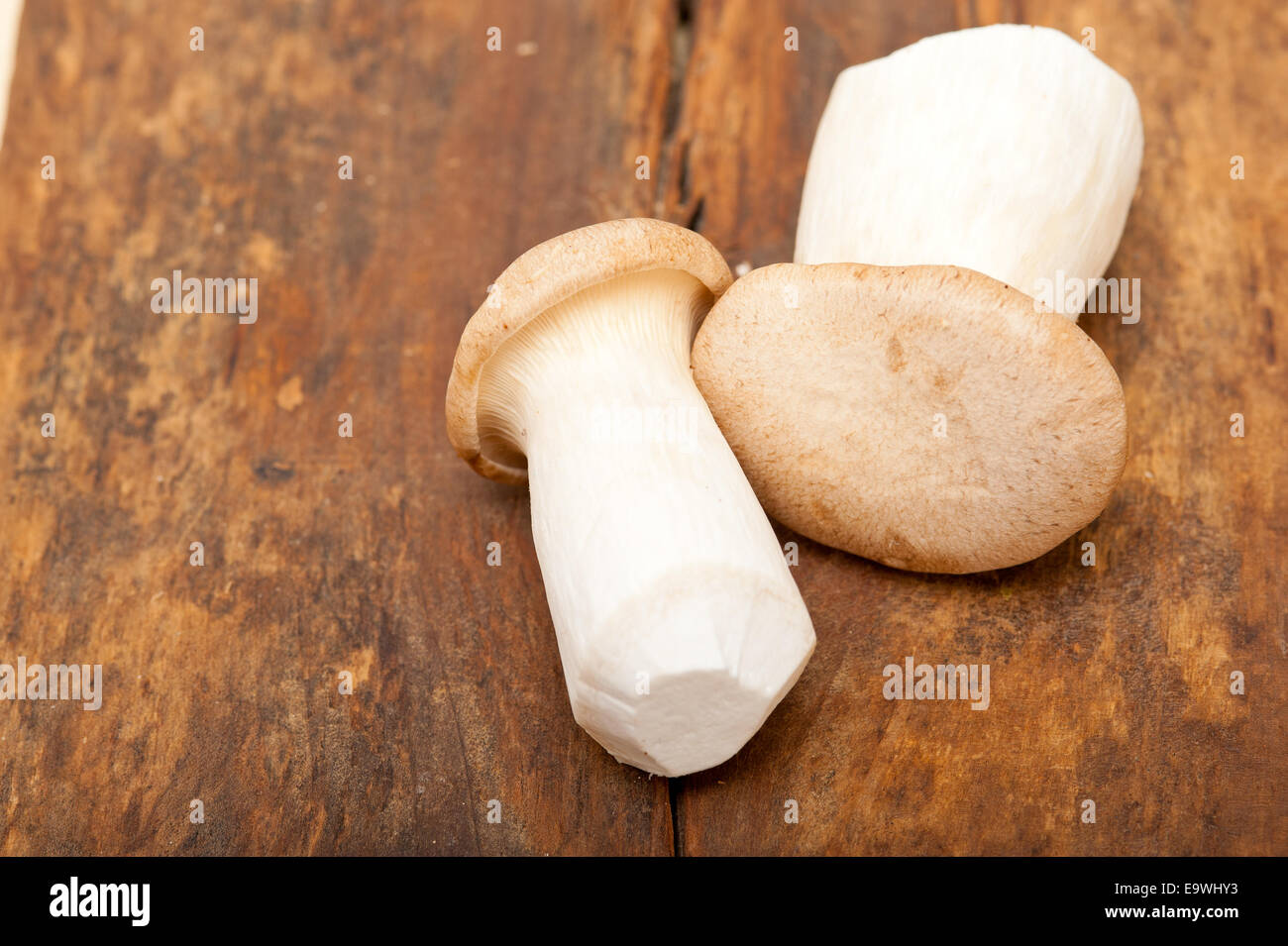bunch of fresh wild mushrooms on a rustic wood table Stock Photo - Alamy
