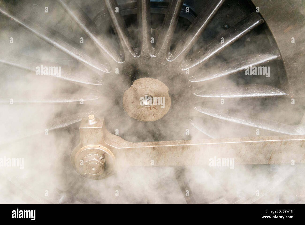 Steam surrounds a drive wheel of the steam engine train, Oliver Cromwell. Steam train is a Britannia Class 7MT 4-6-2 no 70013. Stock Photo