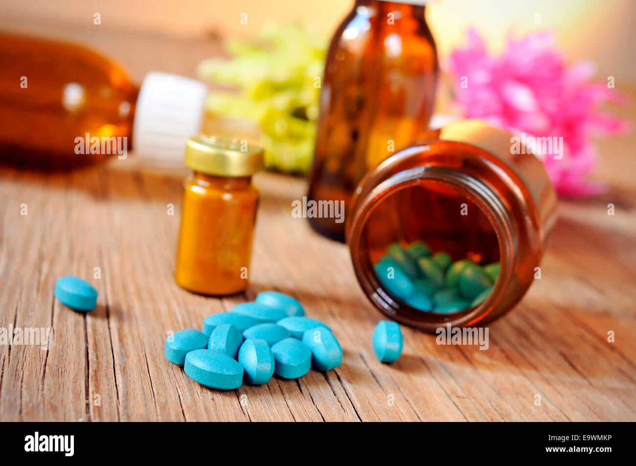 some bottles with different alternative remedies on a rustic wooden table Stock Photo