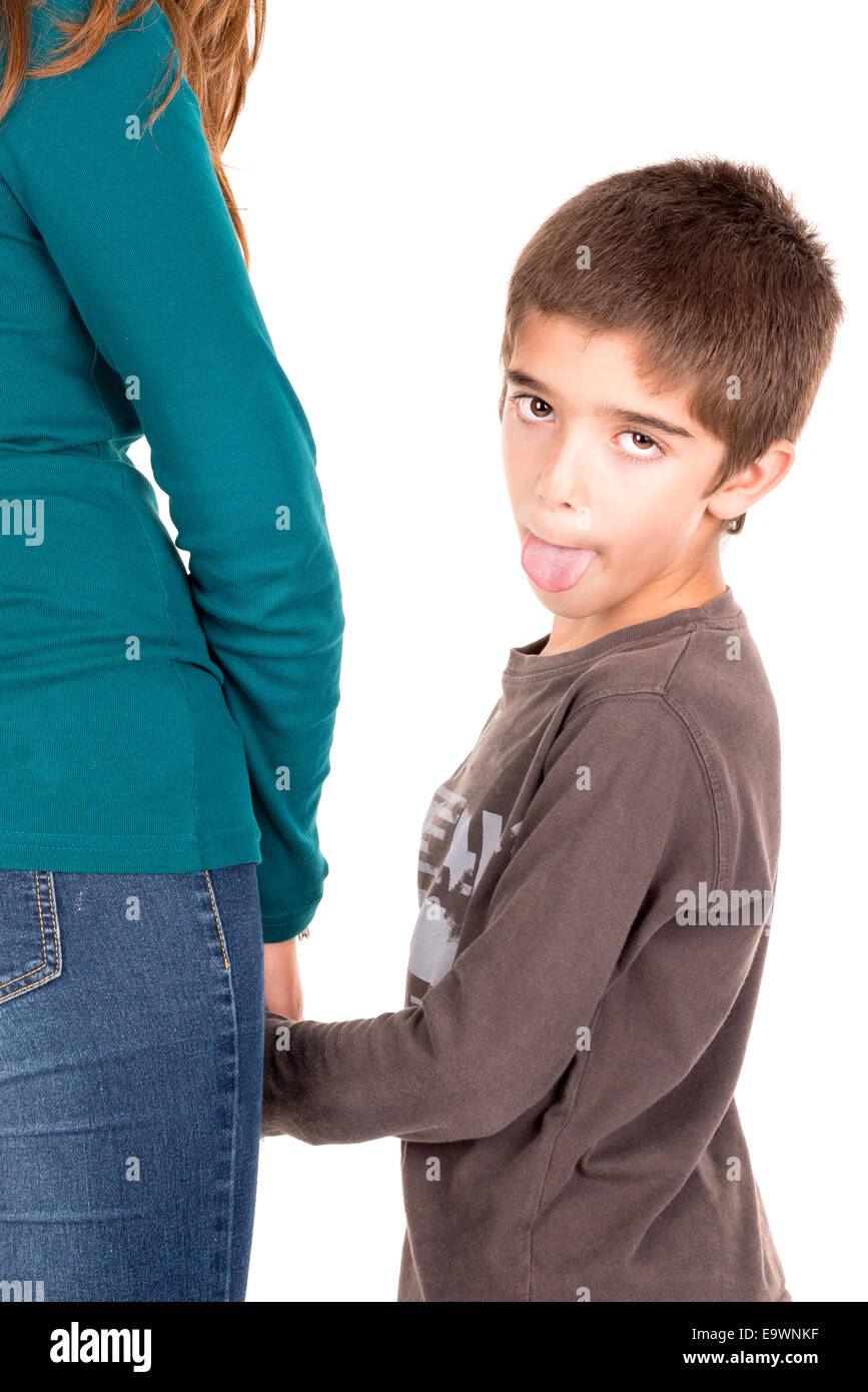 Young boy making faces and holding his mother's hand Stock Photo