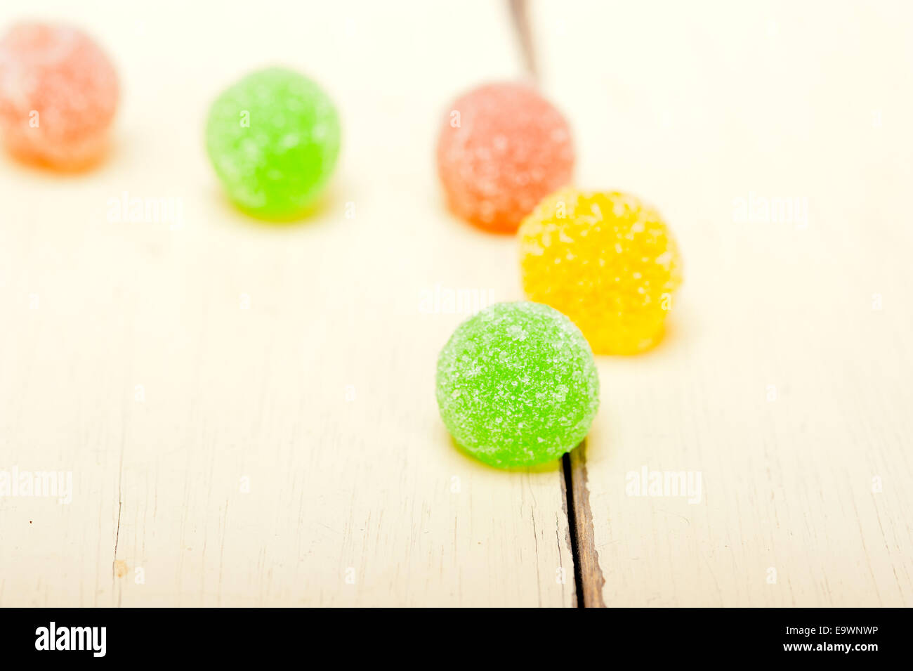sugar jelly fruit candy over white wood table Stock Photo - Alamy