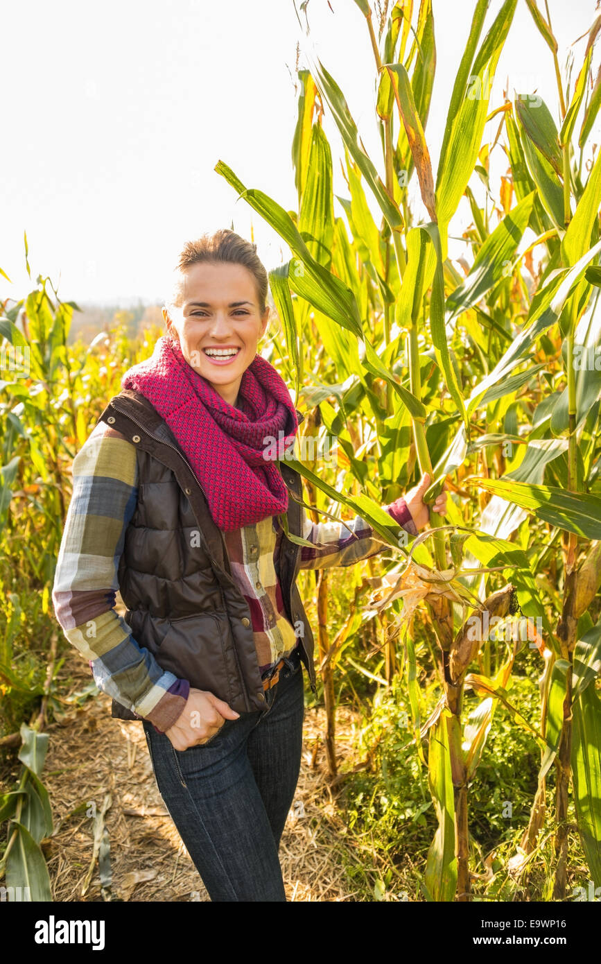Portrait of smiling young woman in cornfield Stock Photo