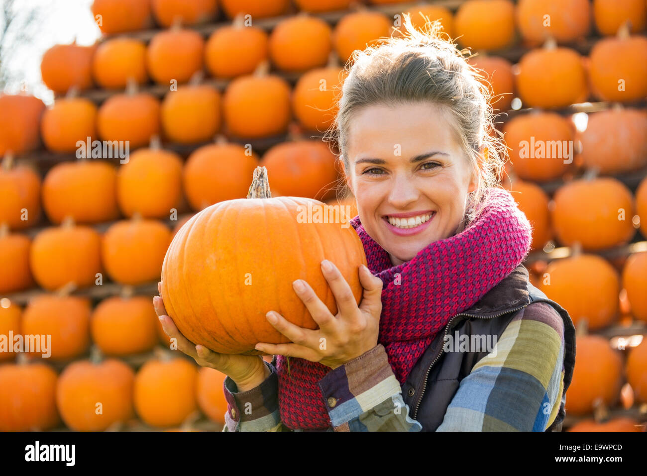 Portrait of smiling young woman holding pumpkin Stock Photo - Alamy