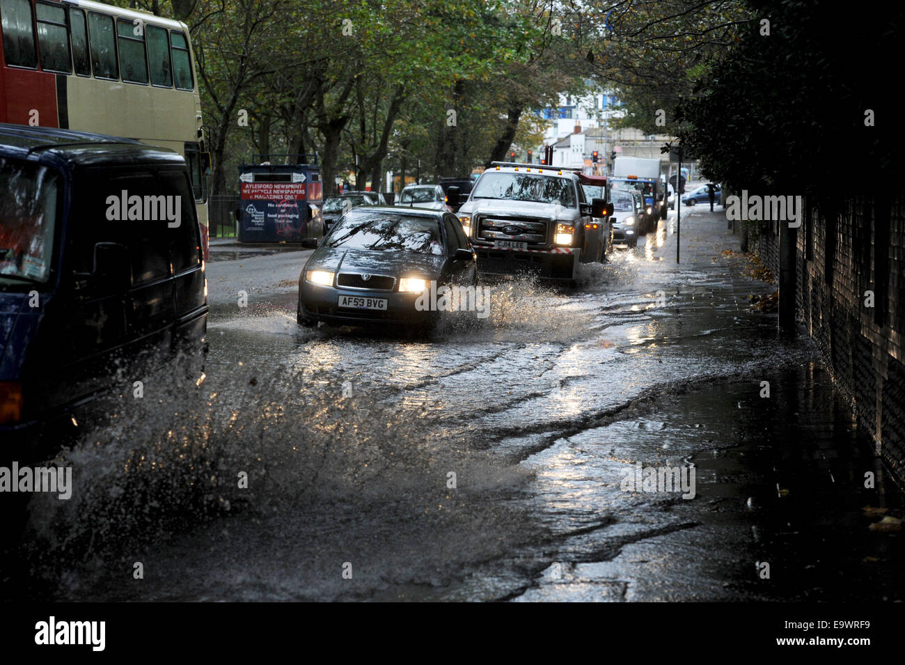 Brighton, Sussex, UK. 3rd November, 2014. UK weather. Traffic drives through flooded roads in the centre of Brighton Stock Photo