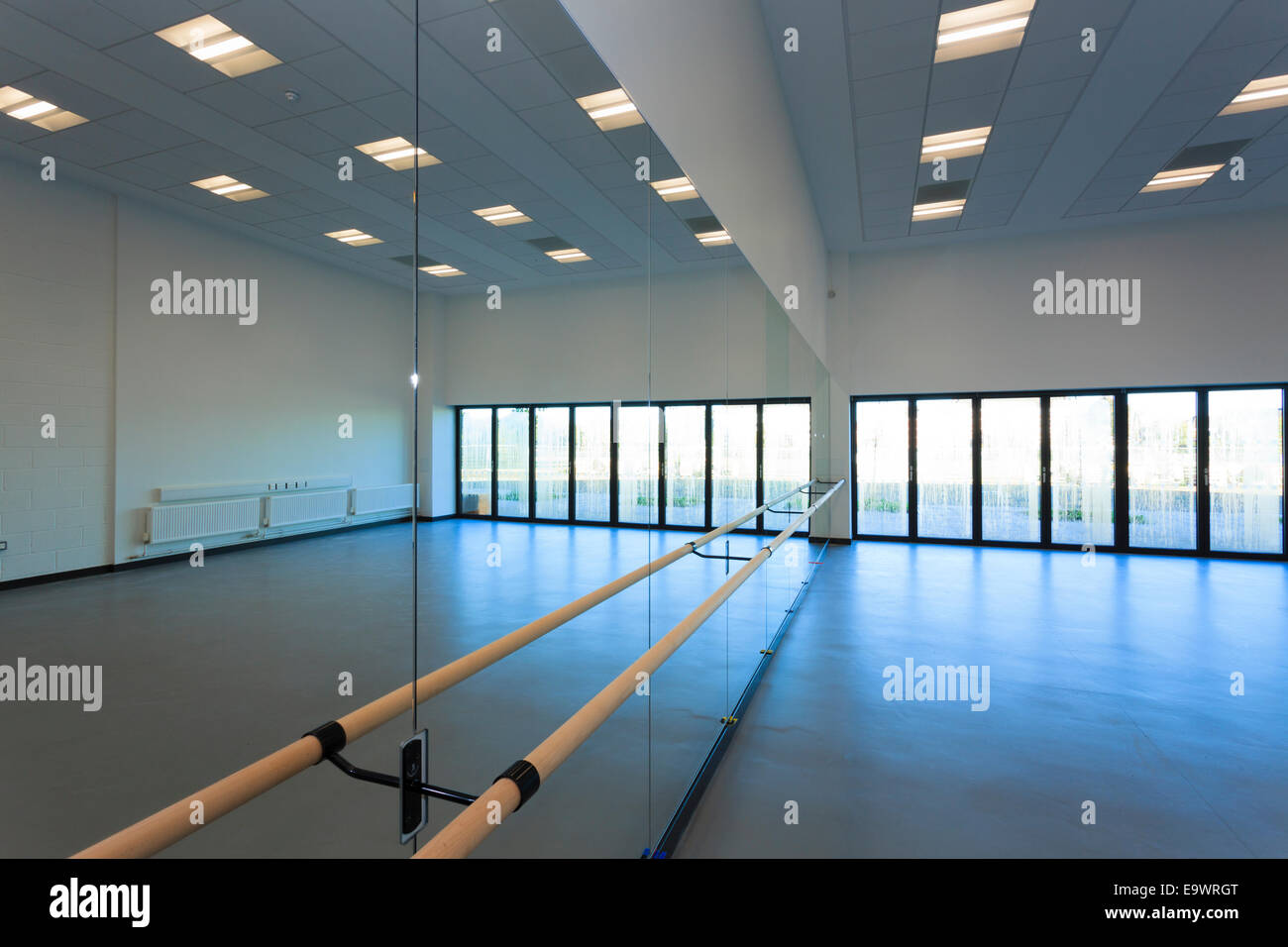 Unoccupied dance studio with mirrors and ballet barre Stock Photo