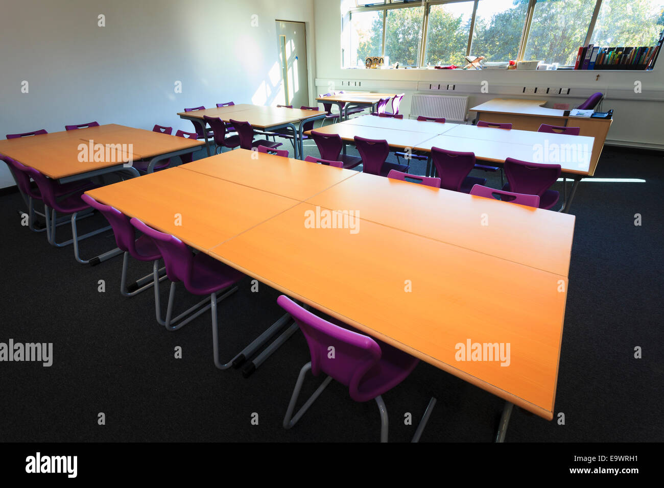 Desks in unoccupied school classroom Stock Photo