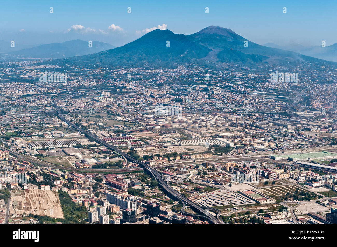 An aerial view of the volcano of Mount Vesuvius towering over the spreading suburbs of Naples, Campania, southern Italy Stock Photo