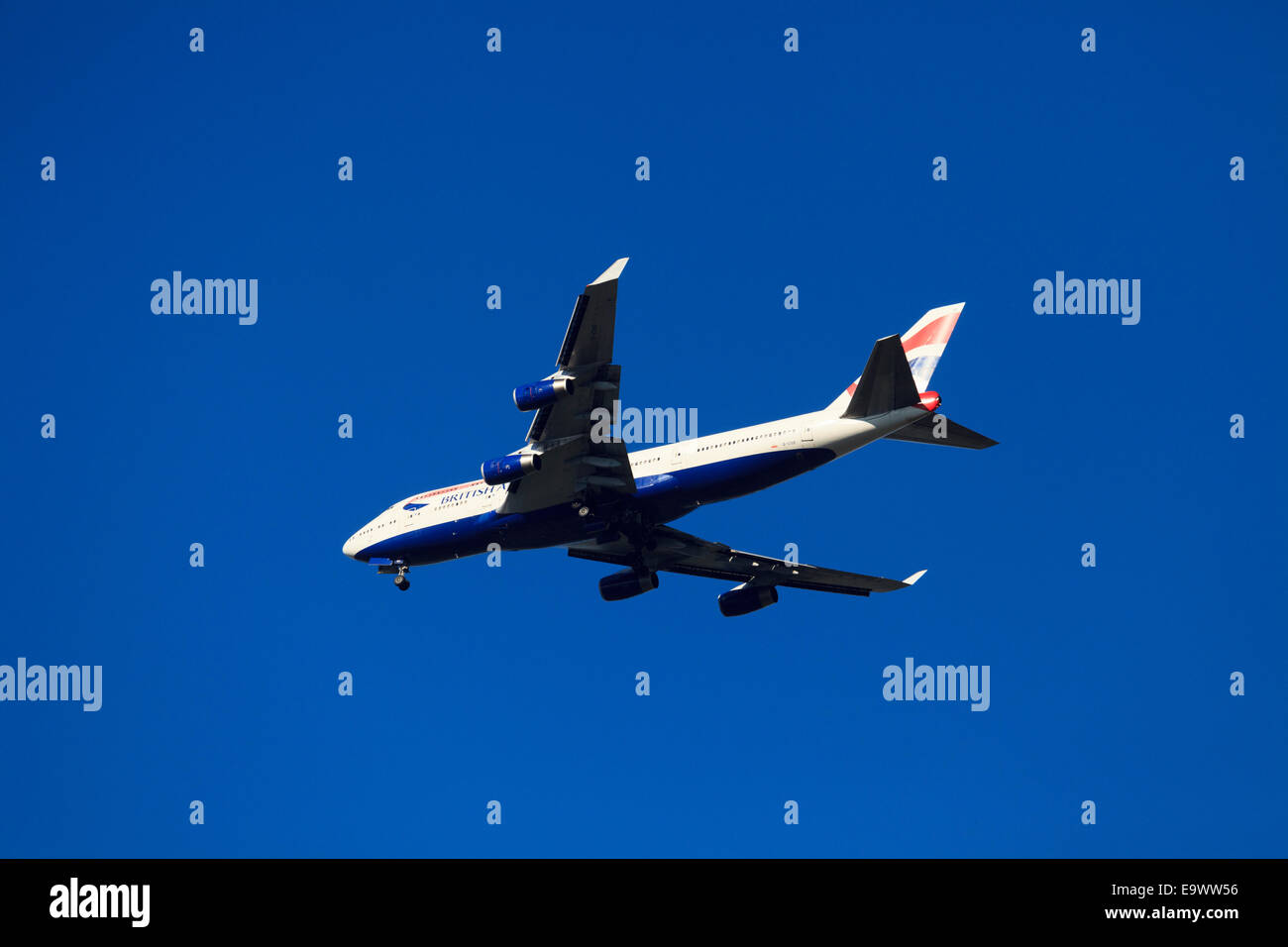 British Airways Boeing 747-436  from underneath against blue sky with undercarriage down Stock Photo