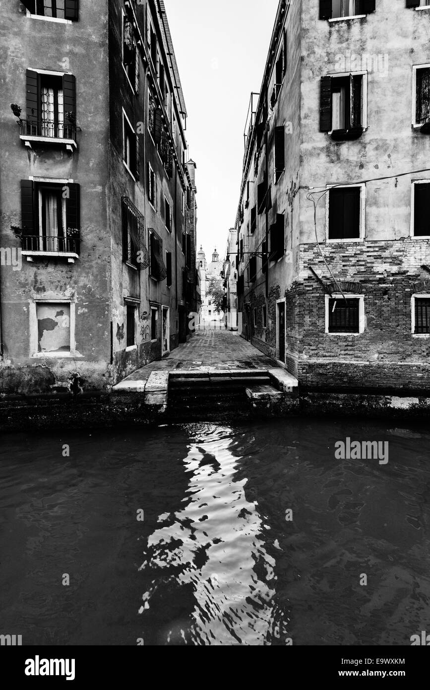 Narrow street and canal in Venice, Italy Stock Photo