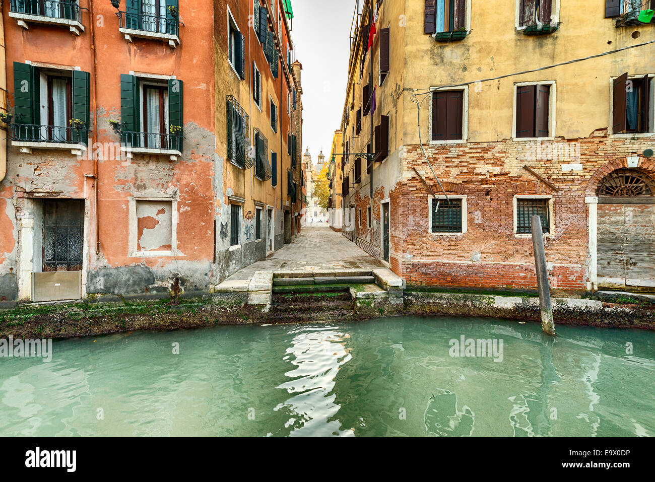 Narrow street and canal in Venice, Italy Stock Photo