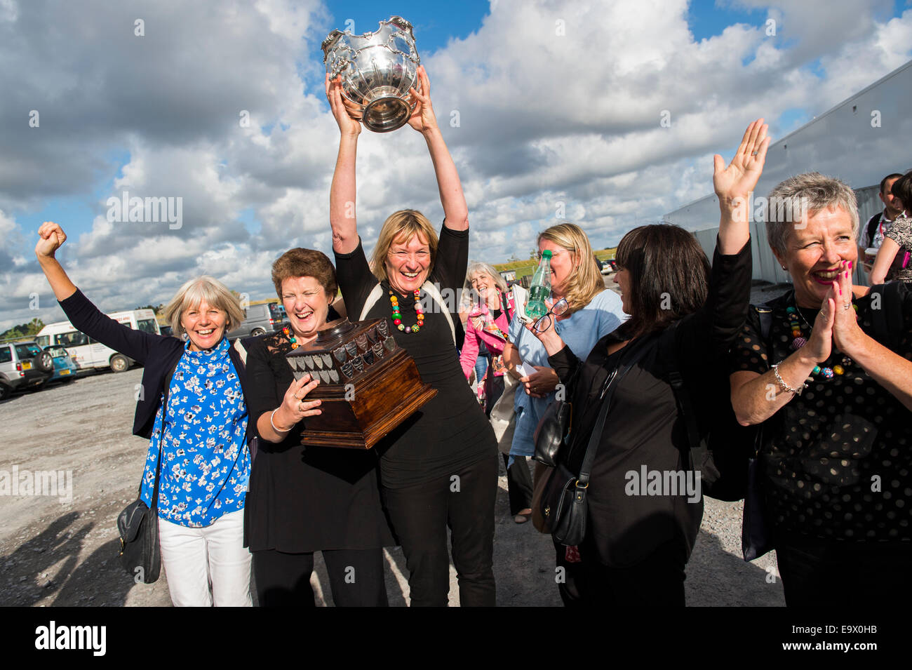 A group of women holding a silver cup aloft celebrating winning  best choir at the National Eisteddfod of Wales, Llanelli, 2014 Stock Photo