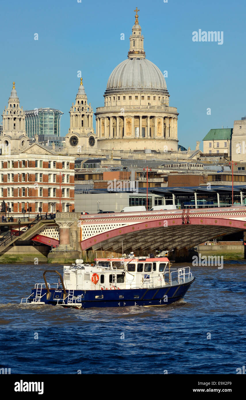 London, England, UK. Port of London Survey boat passing under Blackfriars Bridge, St Paul's Cathedral behind Stock Photo