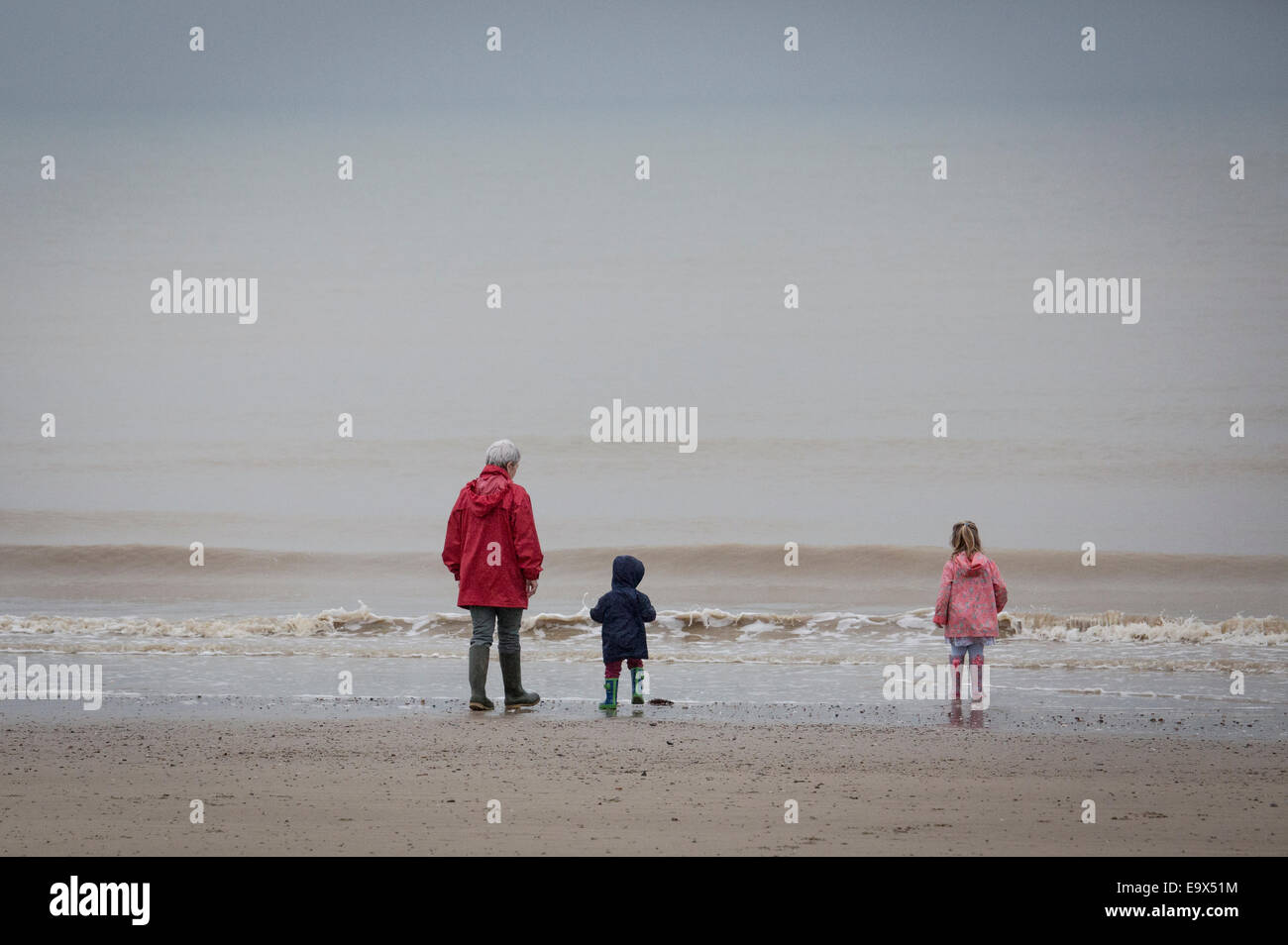 A family walking on the beach at Littlehampton, West Sussex Stock Photo