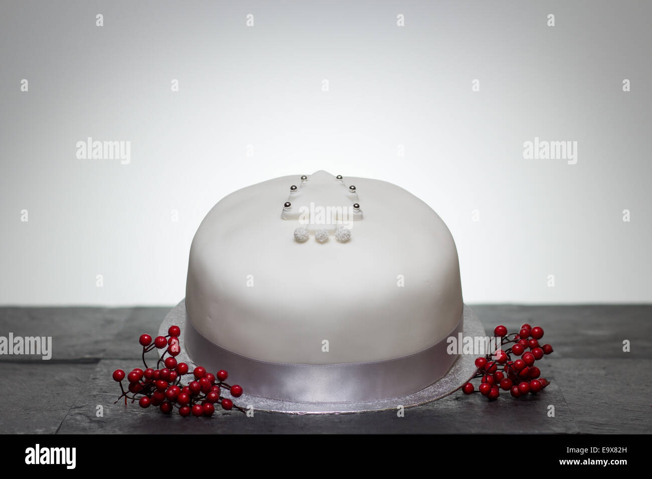 a Christmas cake presented with royal icing and a Christmas tree motif Stock Photo