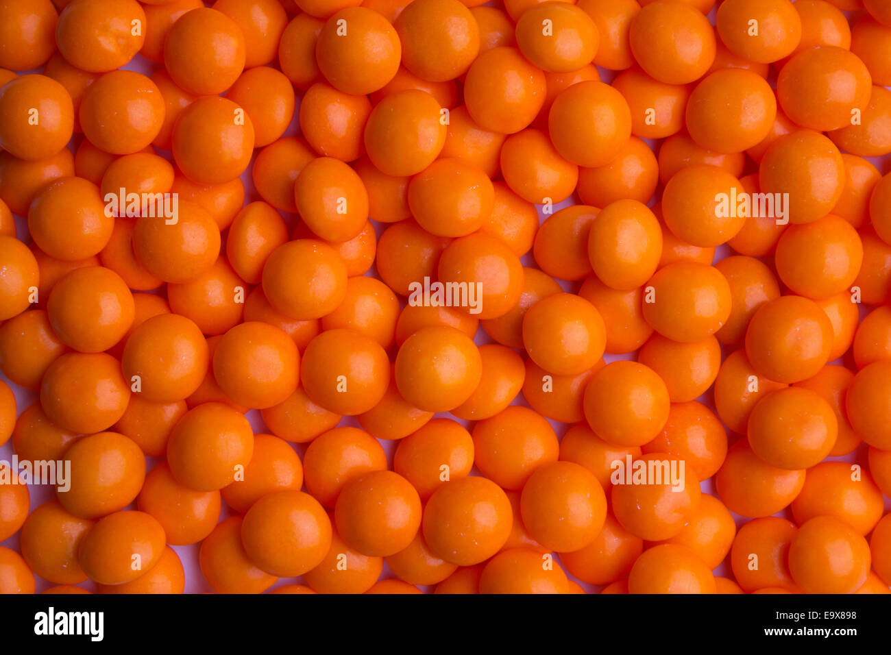 Background of coated orange candy Stock Photo