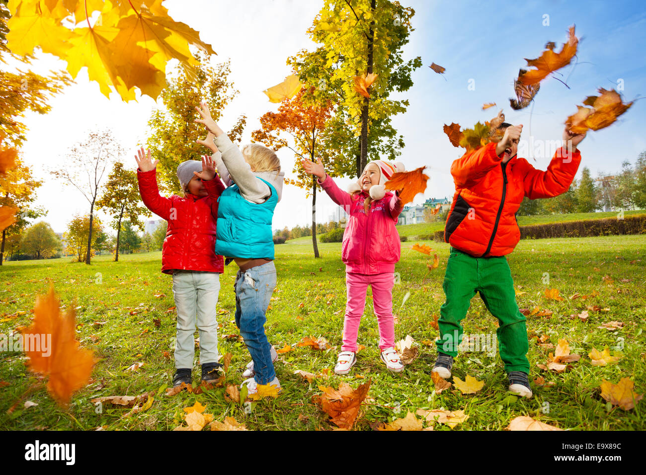 Happy children playing with flying leaves in park Stock Photo - Alamy