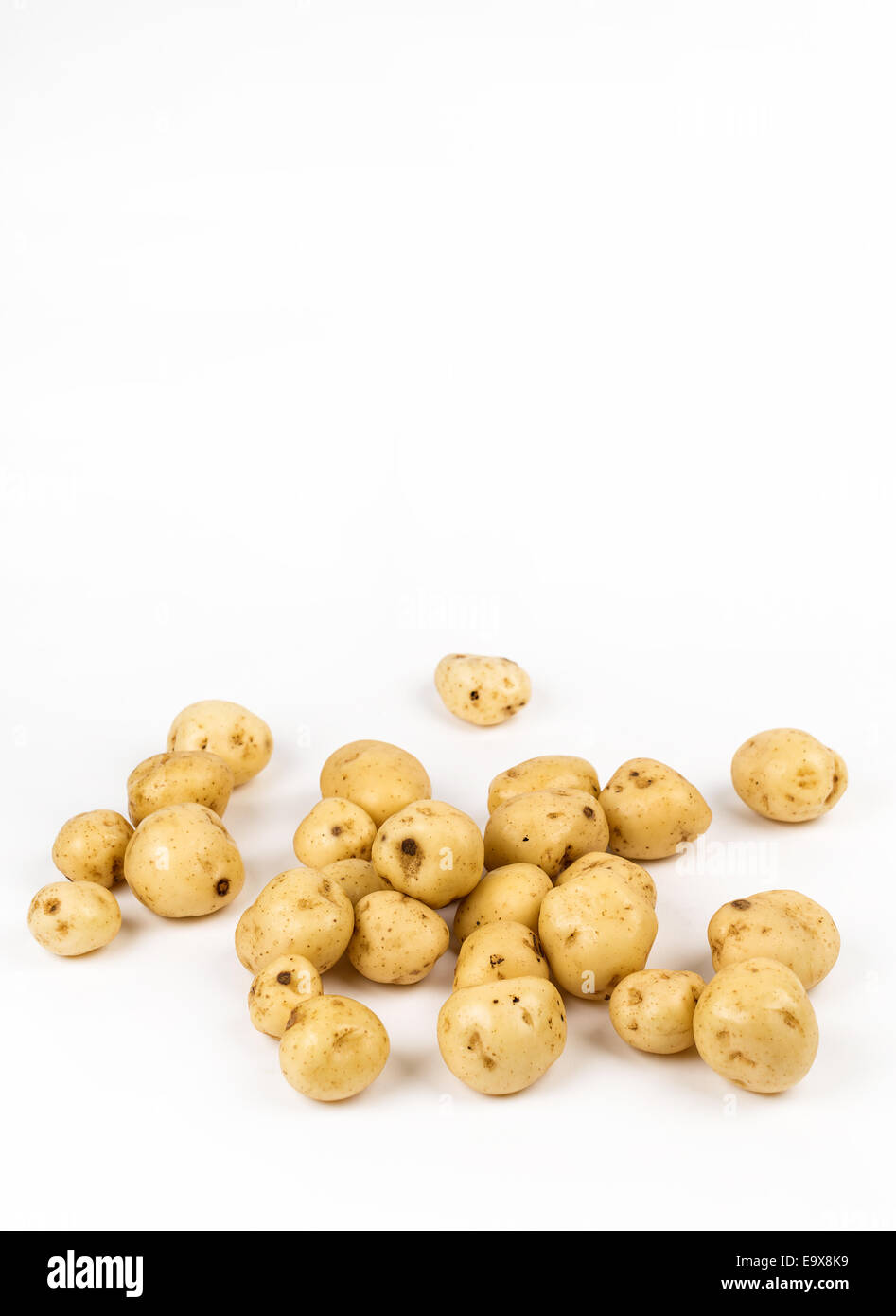 Loose new potatoes on white background Stock Photo