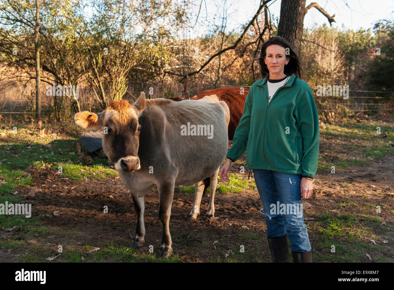 A female farmer with a milk cow on the farm; Grannis, Arkansas, United