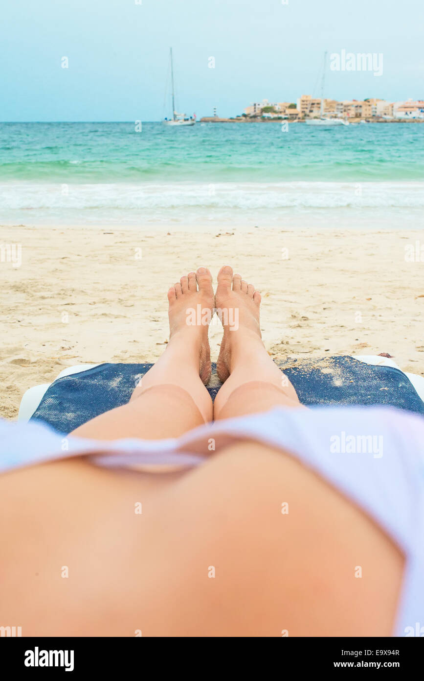 Woman lying on the beach. Legs. Stock Photo
