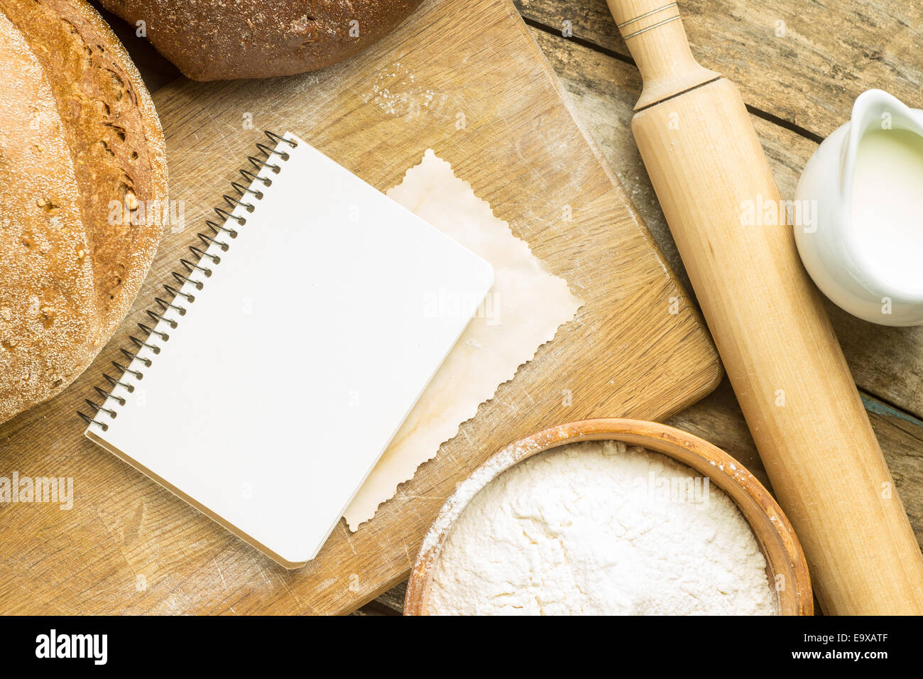 Menu background. Bakery ingredients with blank recipe book on wooden table Stock Photo