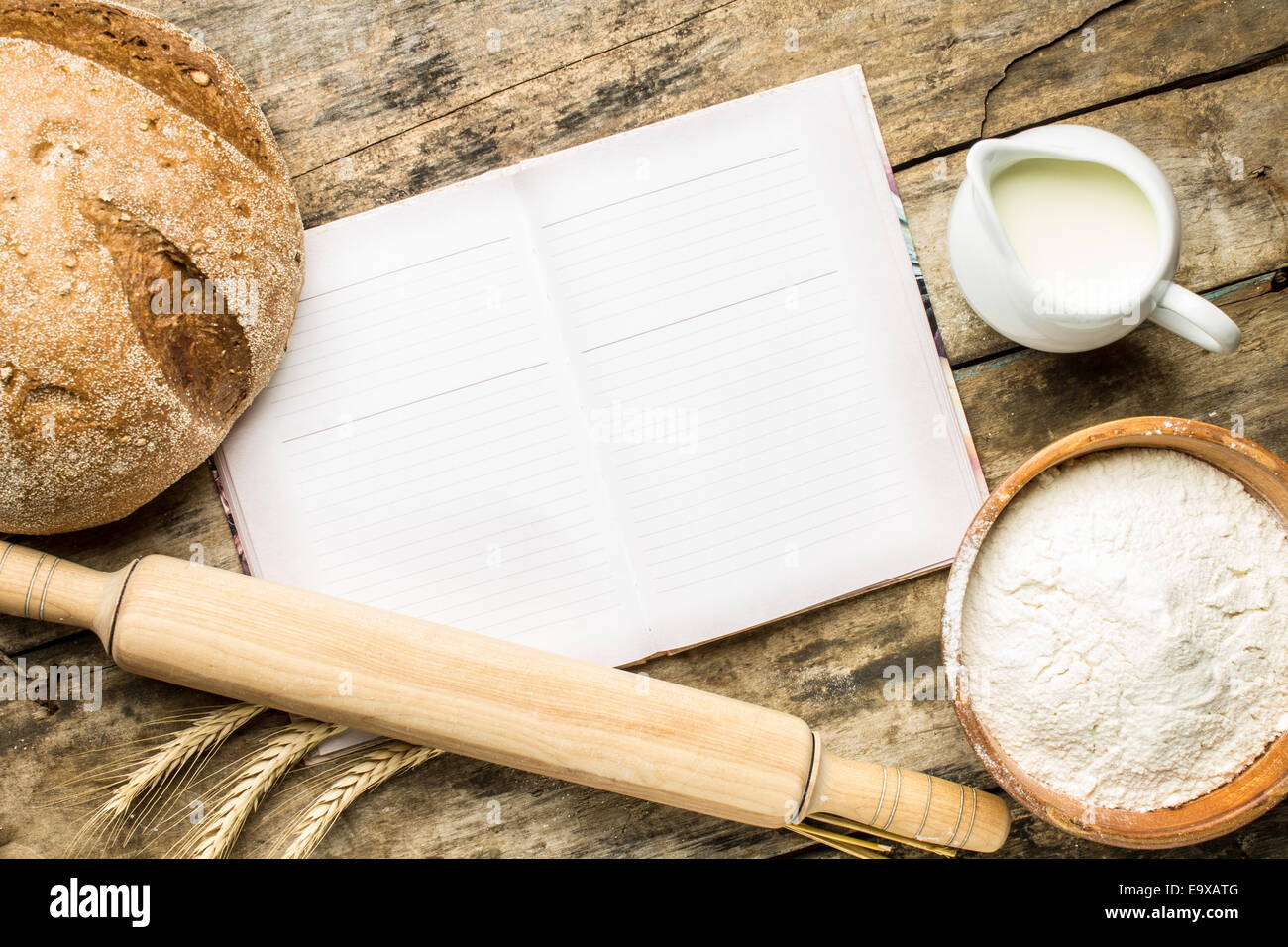 Opened cookbook with bakery background on wooden table. Recipe and menu  background Stock Photo - Alamy