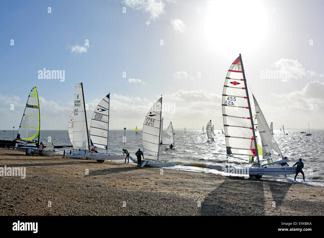 Preparing to launch sailing dinghies into the Thames Estuary from Shoeburyness beach on a cold windy February day Stock Photo
