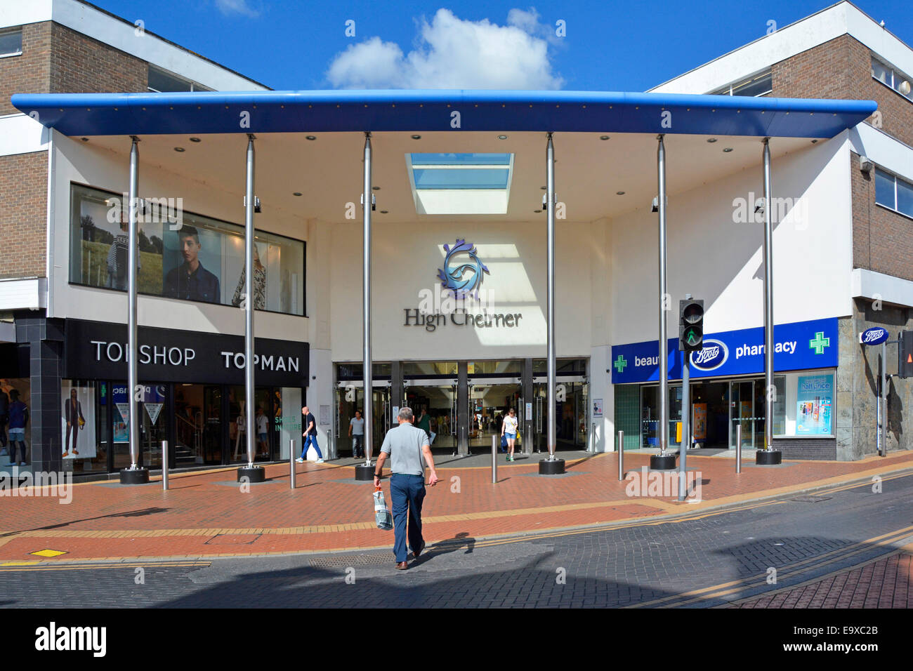 Back summer view of male shopper walking to entrance of High Chelmer Shopping Centre indoor mall Boots Pharmacy & Topshop stores Chelmsford Essex UK Stock Photo