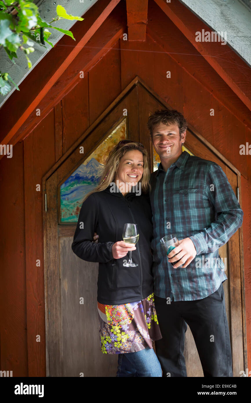 Visiting couple pose along the boardwalk, Halibut Cove, Southcentral