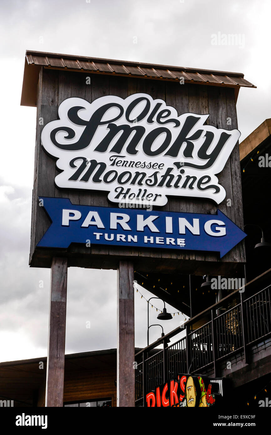Overhead sign pointing to the Ole Smoky Tennessee Moonshine Holler and Parking in Gatlinburg TN Stock Photo