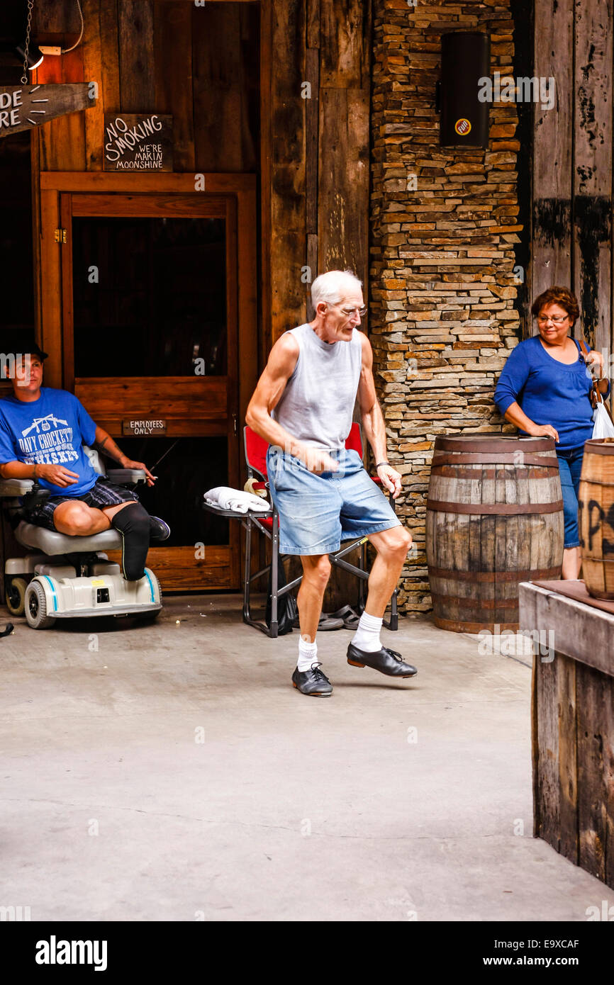 Senior male dancing to the music being played by an Appalachian folk band in Gatlinburg TN Stock Photo