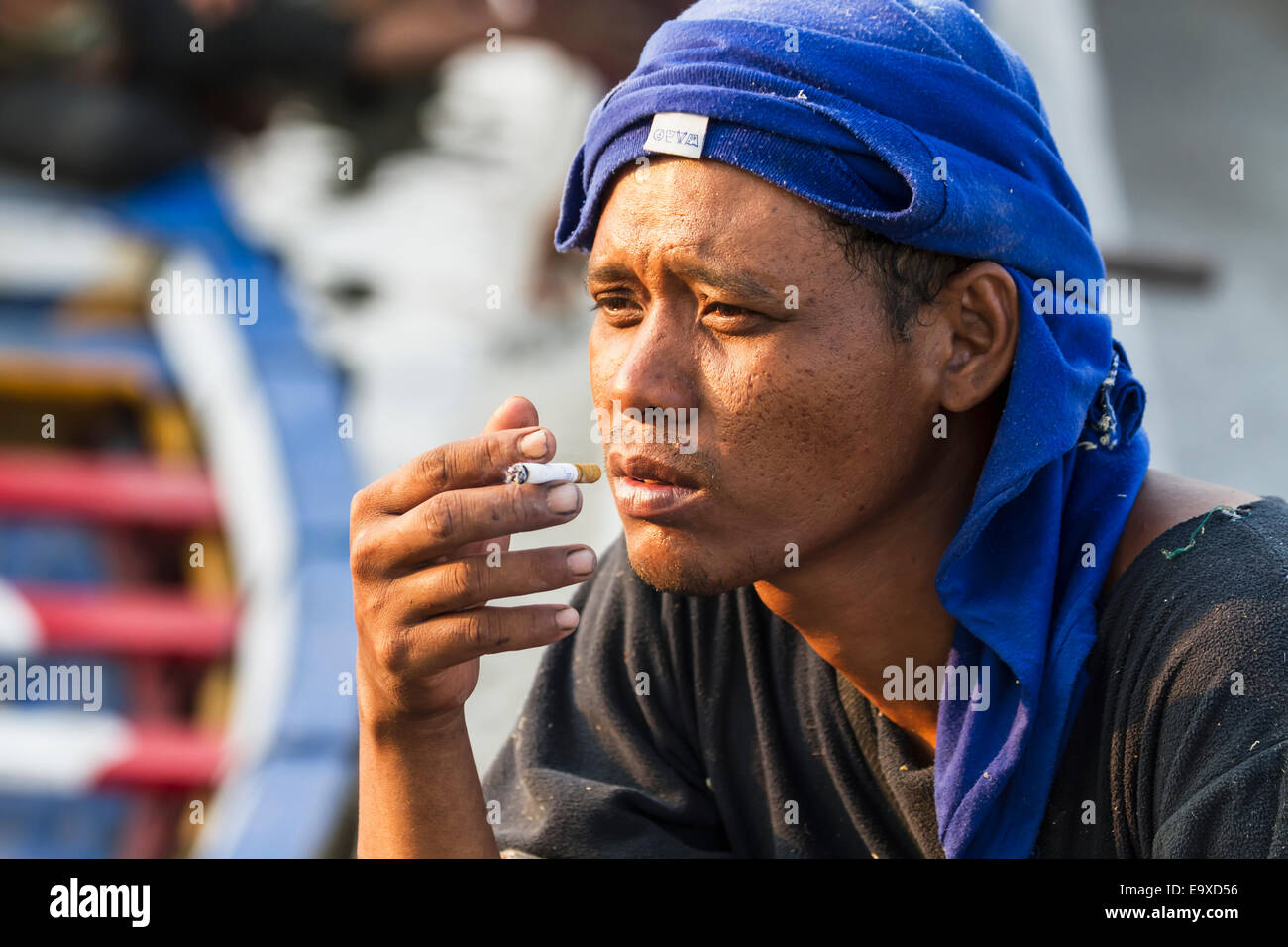 Man smoking a cigarette in Sunda Kelapa Harbour, Jakarta, Java ...