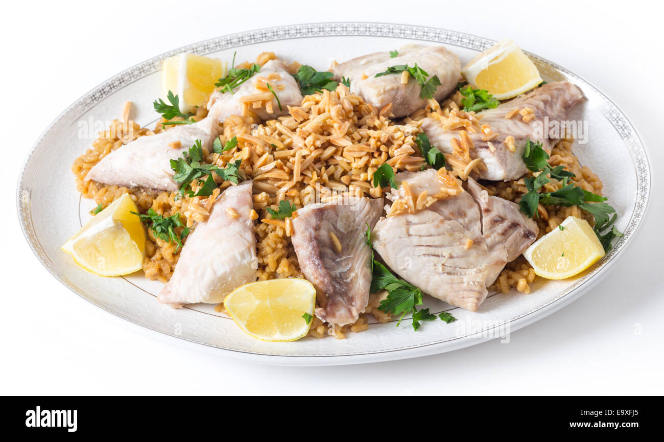 Lebanesesstyle fried fish on a serving dish with caramelised onion