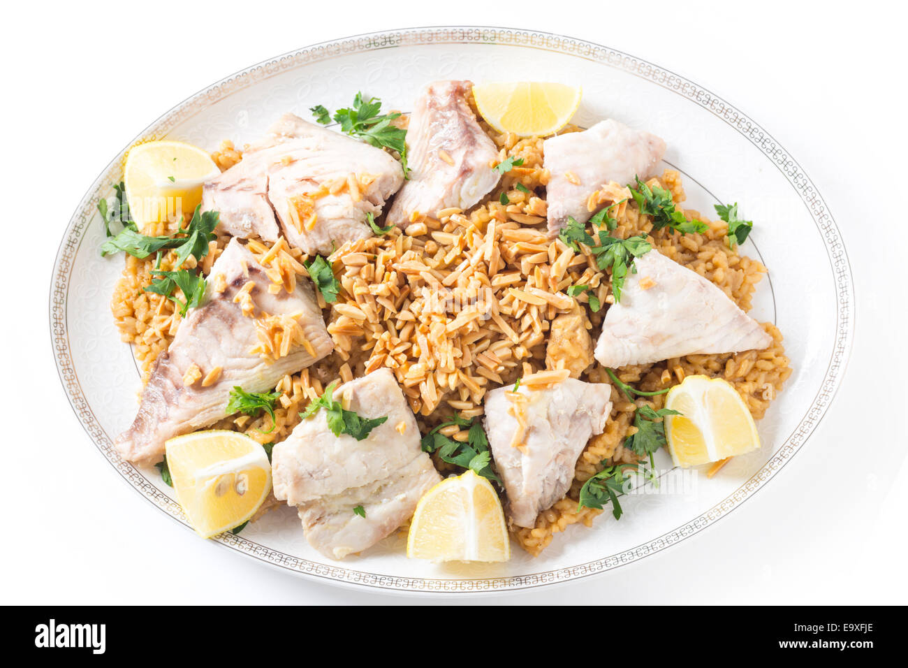 Lebanesesstyle fried fish on a serving dish with caramelised onion