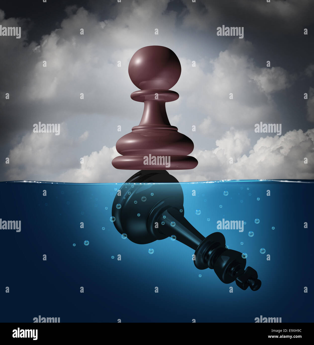 Winner and champion success concept as a chess pawn piece standing on top of a drowning king as a business metaphor for victory Stock Photo