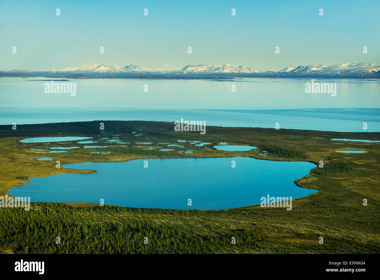 Aerial view of Lake Iliamna and the Alaska Range in early summer, Southwestern Alaska Stock Photo