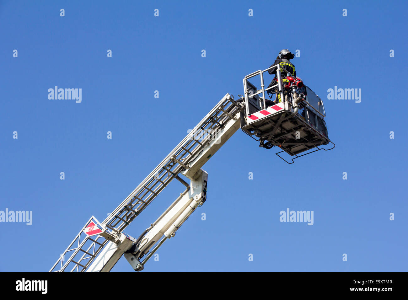 Ladder truck with firefighter and blue sky background Stock Photo