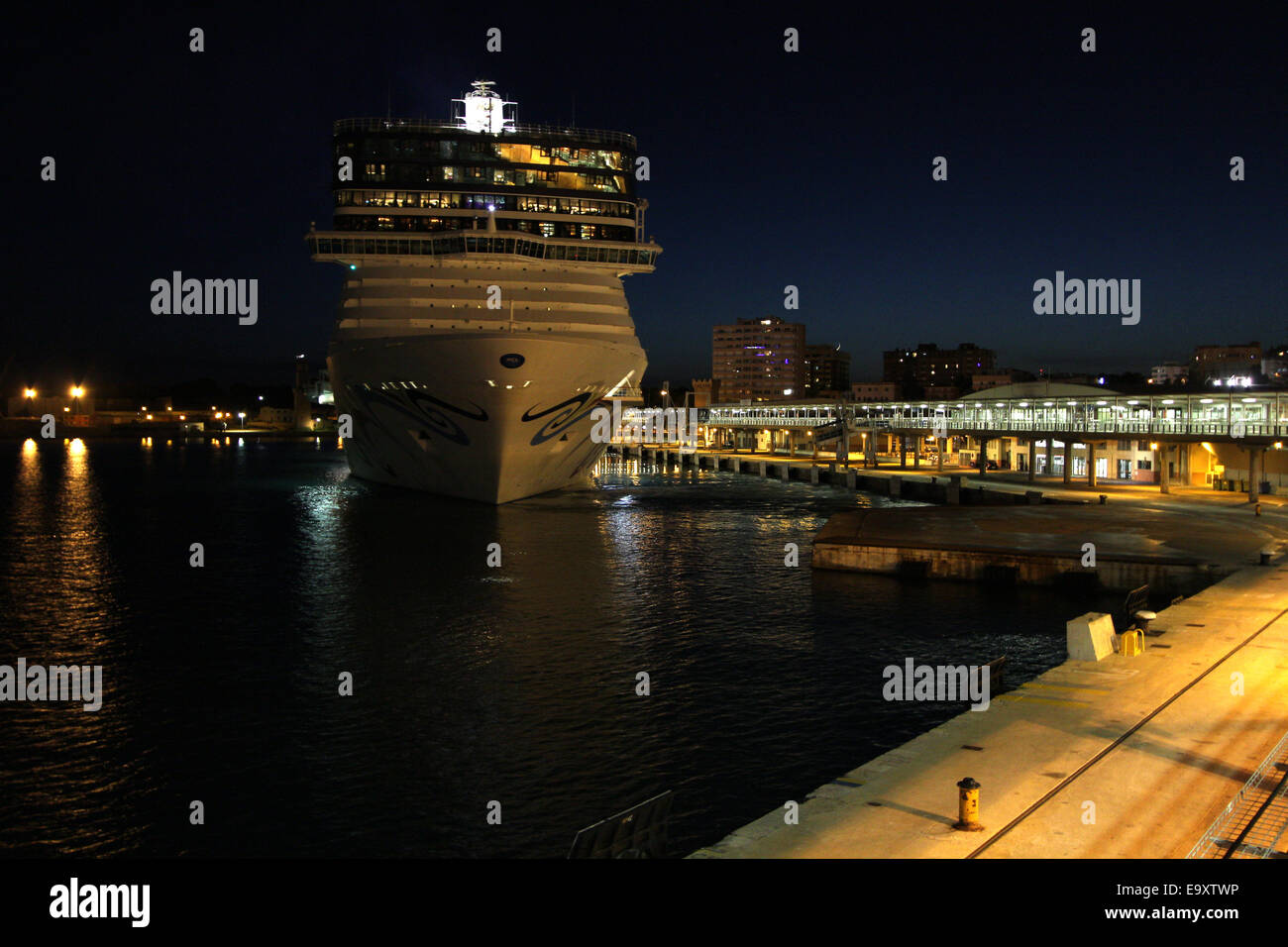 Norwegian Cruise Line (NCL) Cruise ship “NORWEGIAN EPIC” (325 mtrs)  - slipping away from quay at dusk  - Port of Palma Stock Photo