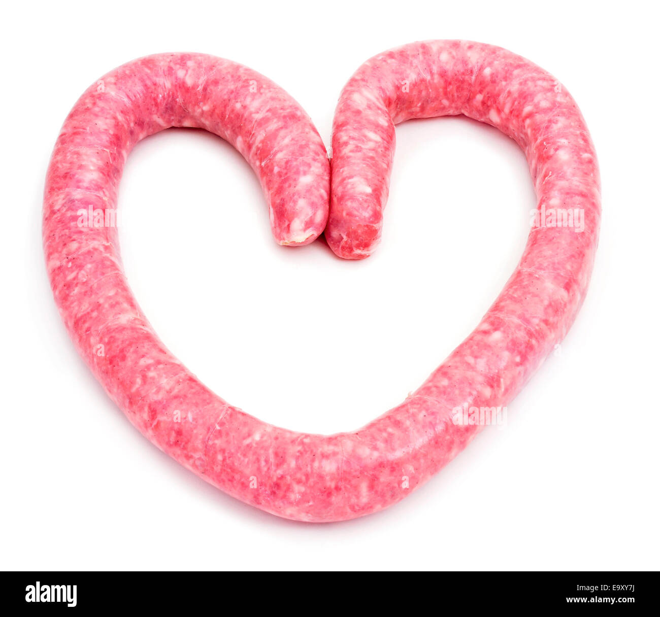 an uncooked pork meat sausage forming a heart on a white background