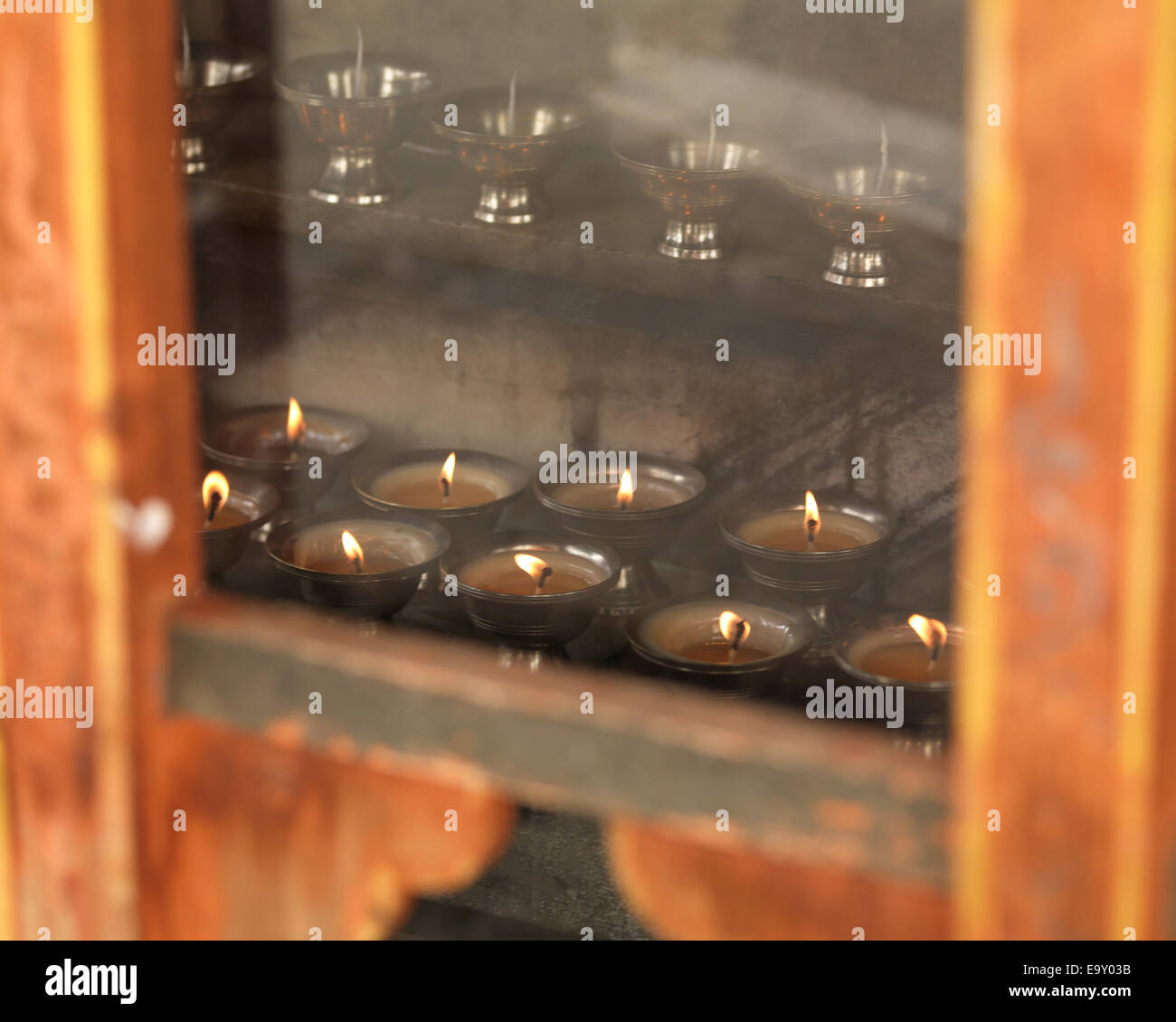 Oil lamps burning in Tango Monastery, Thimphu, Bhutan Stock Photo