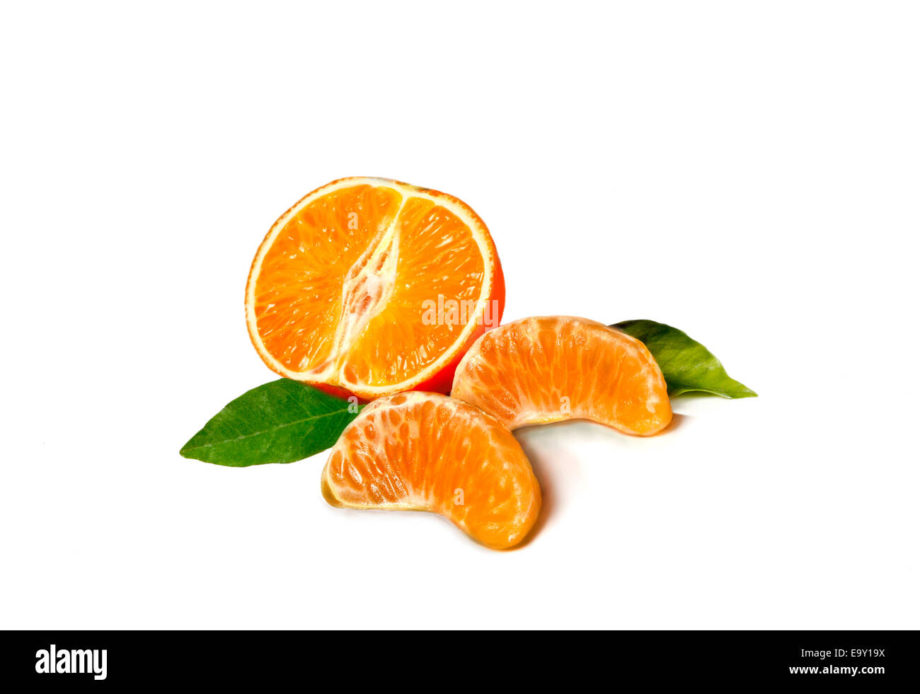 Half a Mandarine and two pieces of Mandarine Stock Photo