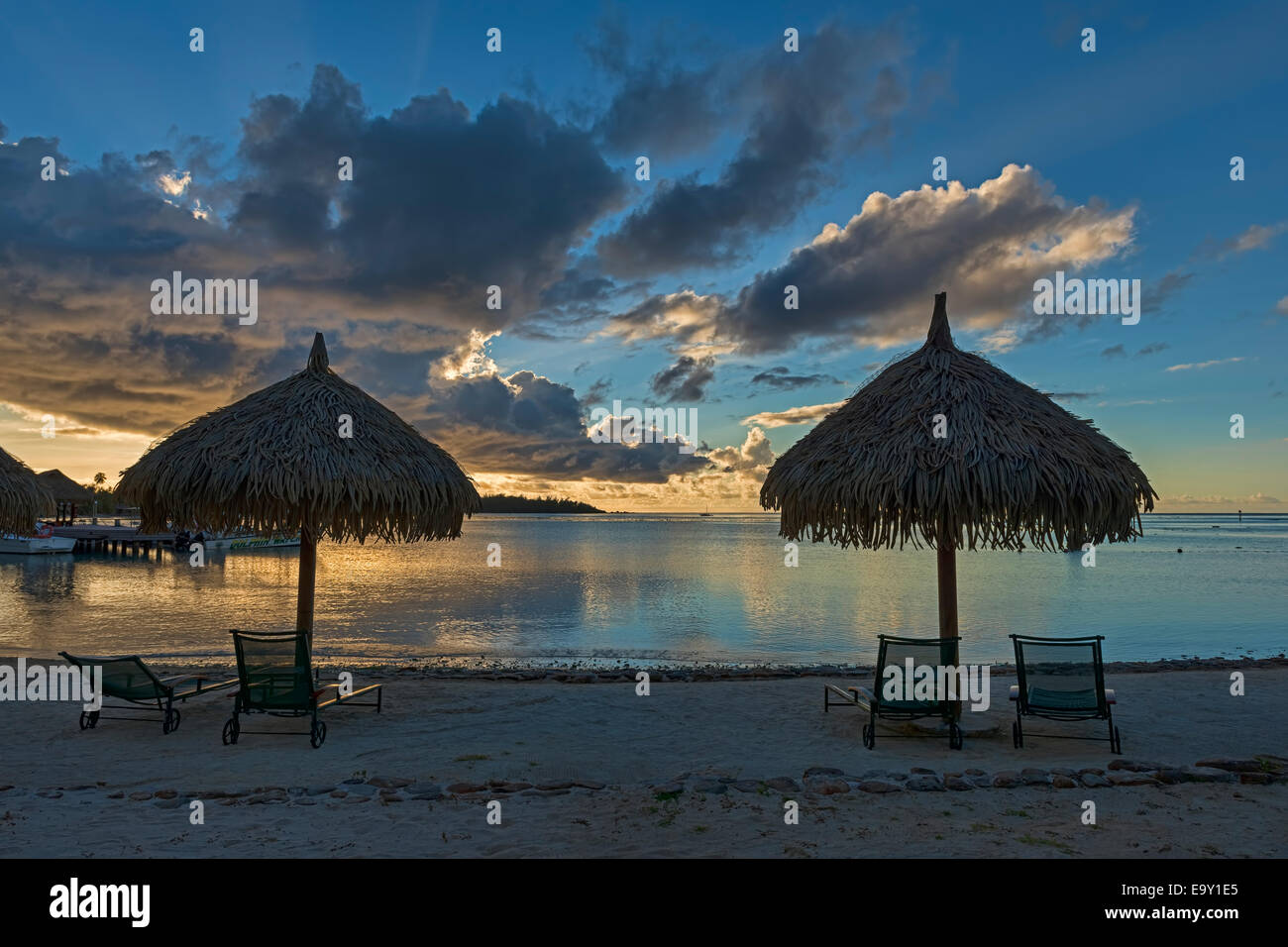 Parasols and sun loungers on the beach, evening atmosphere, Moorea, French Polynesia Stock Photo
