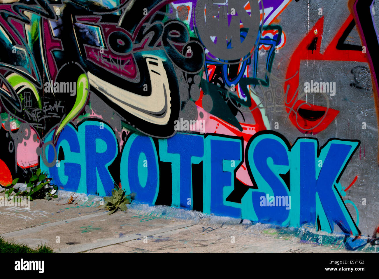Berlin wall graffiti Grotesk colour pavement Stock Photo