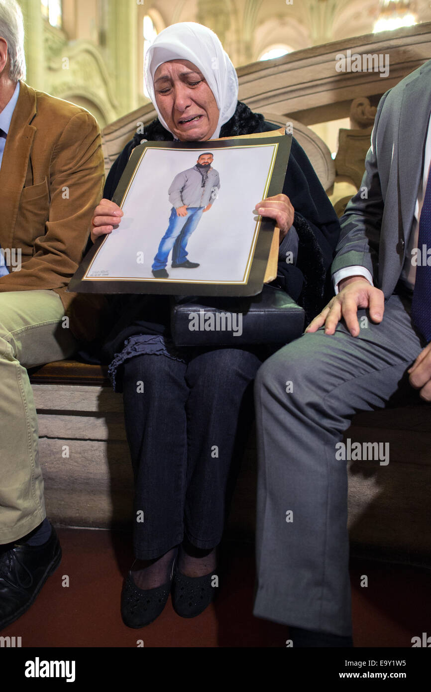 Berlin-Moabit, Germany. 04th Nov, 2014. Mother of murder victim Semiya O. holds a picture of her murdered son outside of the courtroom at the criminal court in Berlin-Moabit, Germany, 04 November 2014. The trial starts on Tuesday against eleven bikers who are charged with killing a 26 year-old man in a betting agents in Berlin in January. Photo: MATTHIAS BALK/dpa/Alamy Live News Stock Photo