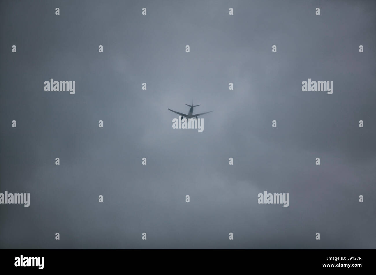 Aircraft flying through rain clouds Stock Photo Alamy