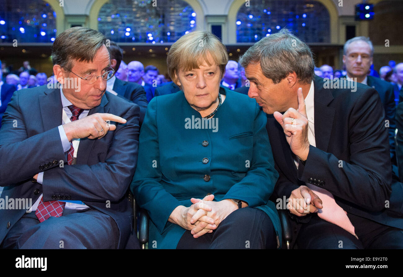 Berlin, Germany. 04th Nov, 2014. Reinhard Goehner (L), BDA main manager, German Chancellor Angela Merkel and Employers' President Ingo Kramer (R) during the German Employers' Conference in Berlin, Germany, 04 November 2014. The annual conference serves as a place to exchange ideas between top representatives from politics, business and society. Photo: BERND VON JUTRCZENKA/dpa/Alamy Live News Stock Photo