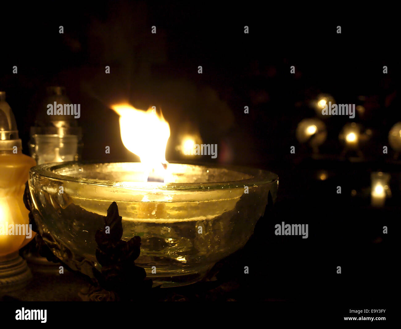 Candles in the cemetery on the day of all saints. Stock Photo