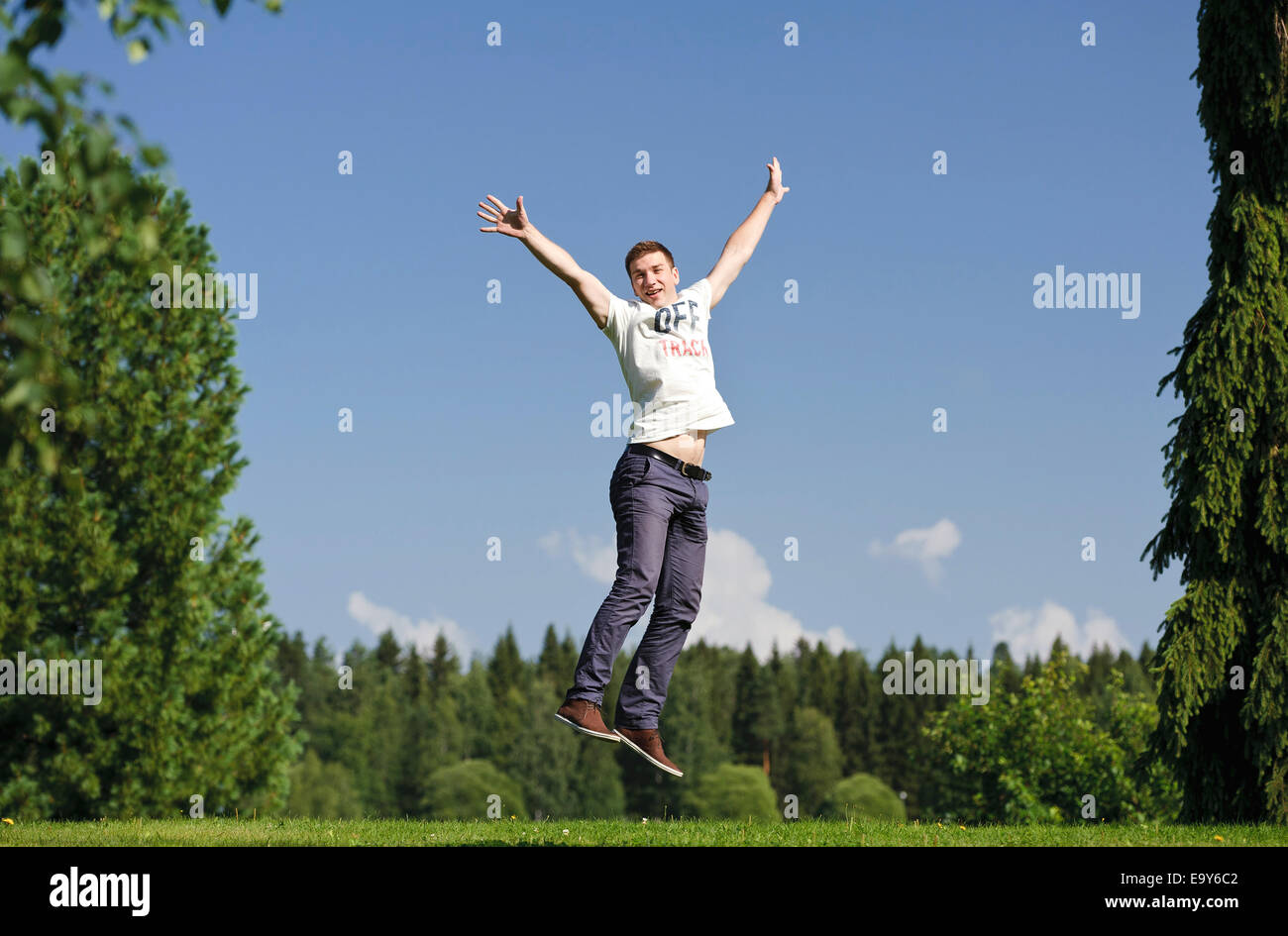 Young man jumping outside Stock Photo - Alamy