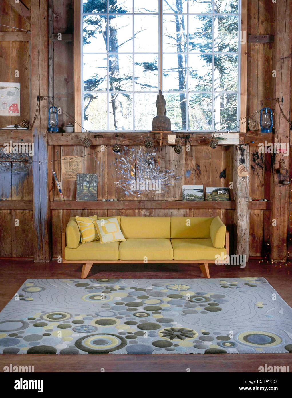 couch and rug in barn studio Stock Photo