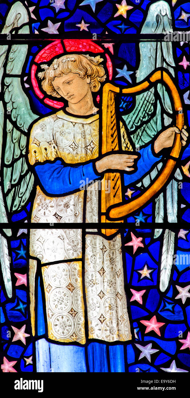 Stained glass depicting a winged angel playing a harp, by William Morris, Staveley Church, Lake District, Cumbria, UK Stock Photo